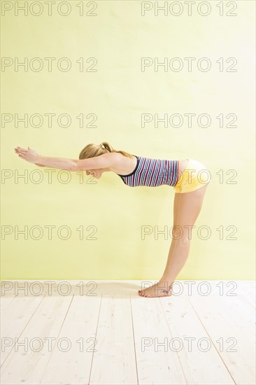 Young woman doing stretching and strengthening exercises