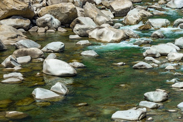 Stones in green clear water