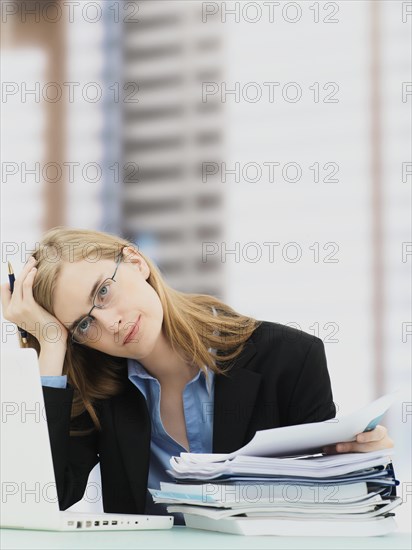 Businesswoman wearing glasses and using a laptop