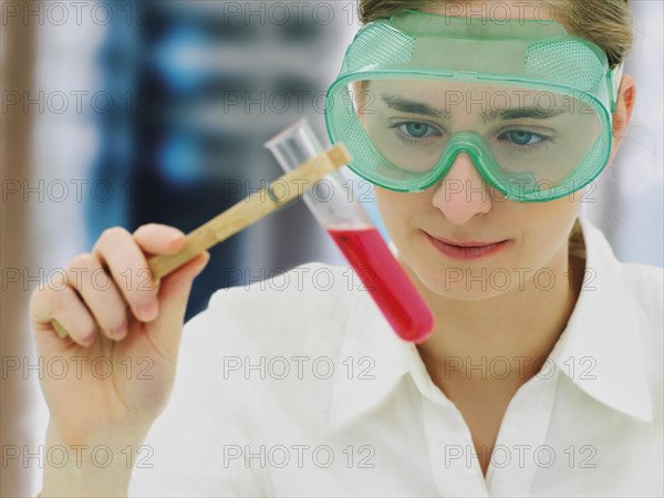 Scientist wearing a protective mask and holding a test tube