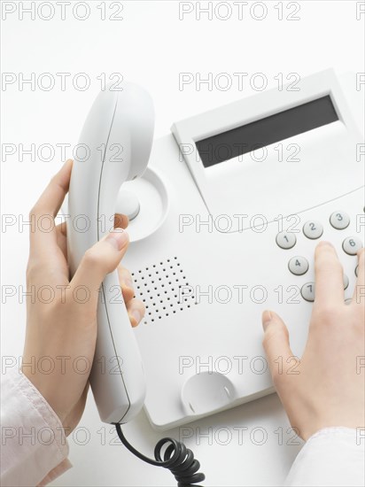 Woman making a call on a telephone