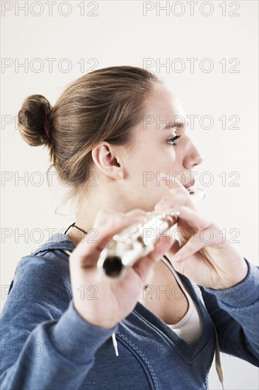 Teenage girl playing the flute