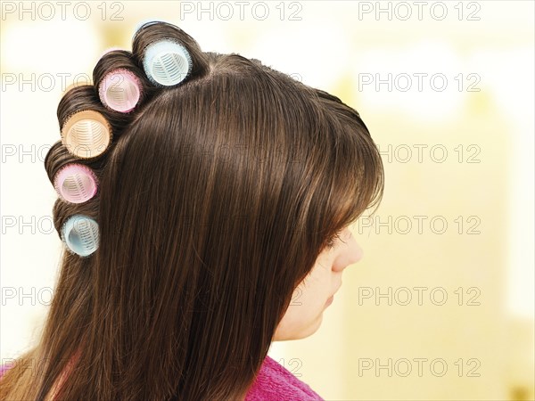 Young girl with curlers in her hair