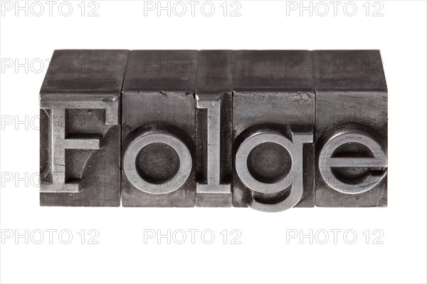 Old lead letters forming the word 'Folge'