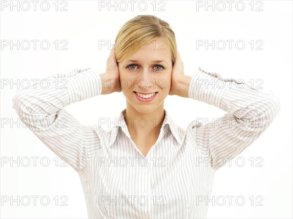 Young woman holding her hands on her ears