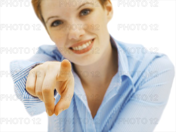 Businesswoman pointing forward with her finger