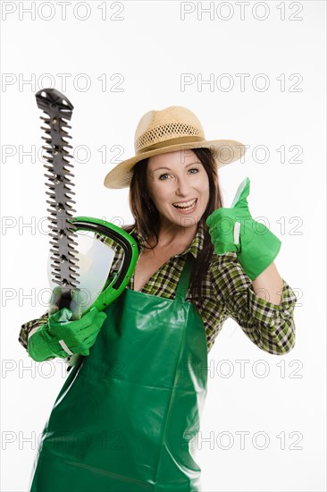 Female gardener holding a hedge trimmer