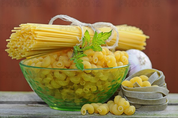 Various types of pasta with a glass bowl