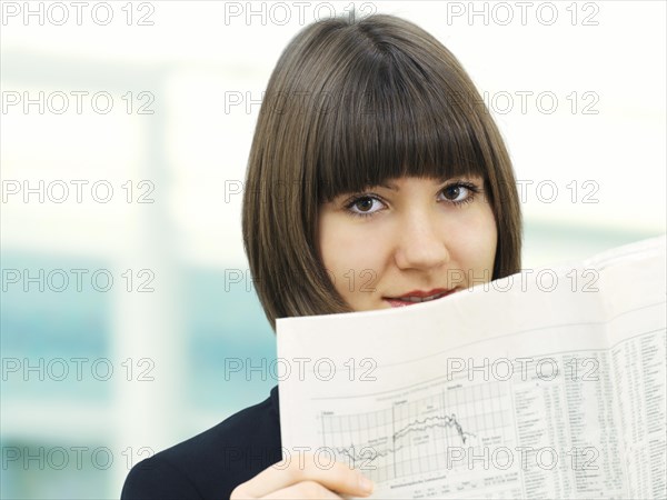 Businesswoman reading a newspaper