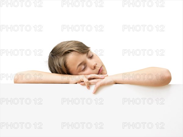 Schoolboy behind a white board