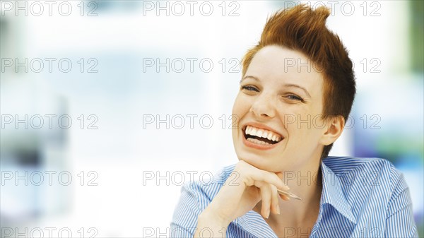 Businesswoman with a punk hairstyle in an office