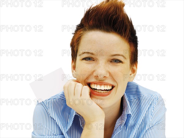 Businesswoman with a punk hairstyle holding a blank business card