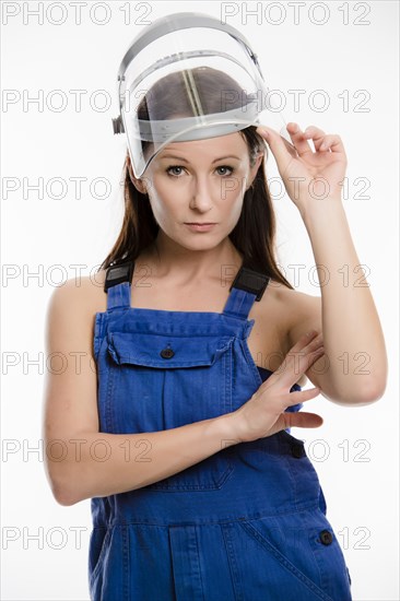 Woman wearing blue overalls and a protective helmet