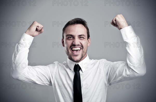 Young man wearing a shirt and a tie cheering