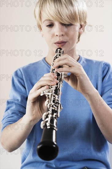 Teenage boy playing the oboe