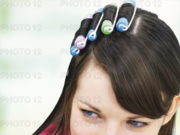 Young girl with curlers in her hair