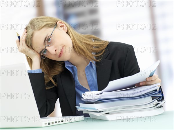 Businesswoman wearing glasses and using a laptop