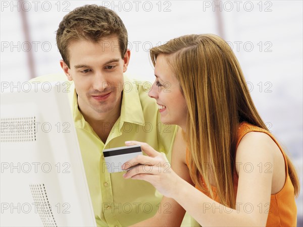 Young couple shopping online with a computer