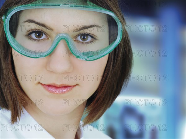 Researcher wearing goggles in a laboratory