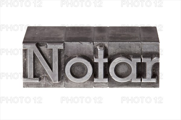 Old lead letters forming the word 'Notar'