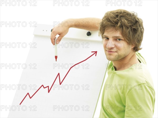 Man standing in front of a flip chart with a rising rate