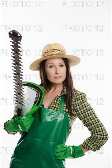 Female gardener holding a hedge trimmer