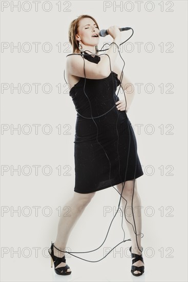 Woman singing into a microphone