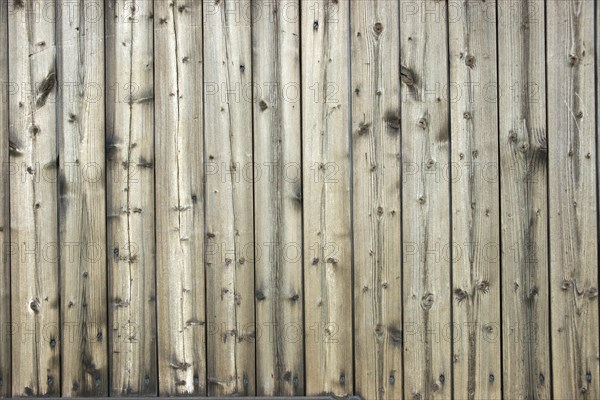 Faded wooden wall of planed boards