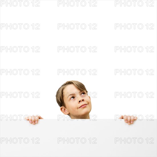 Schoolboy behind a white board