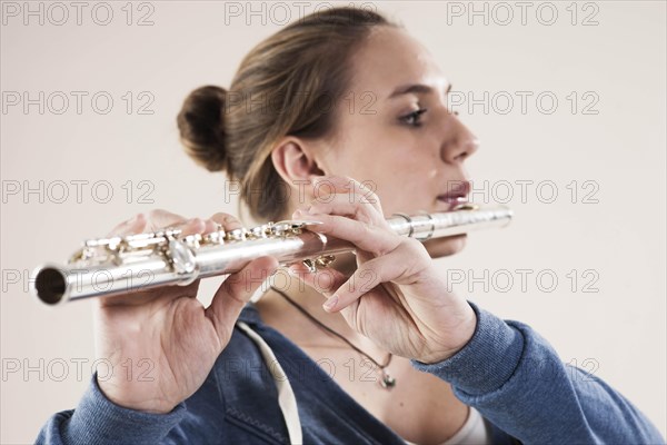 Teenage girl playing the flute