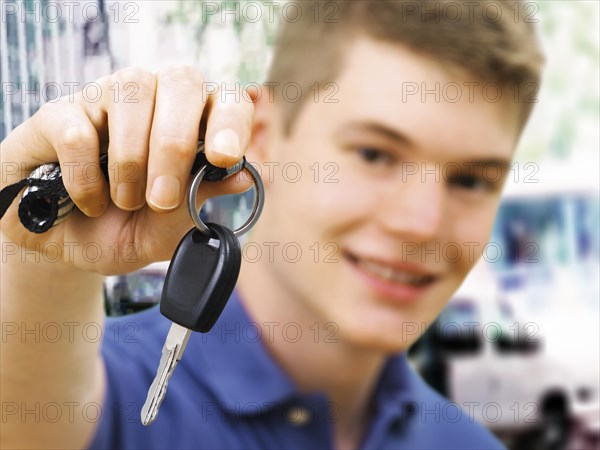 Teenager holding car keys after passing a driving test