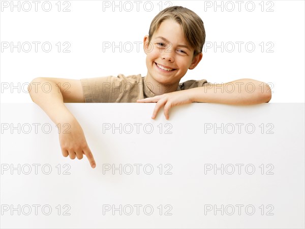 Schoolboy behind a white board