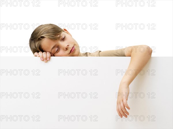 Schoolboy behind a white board