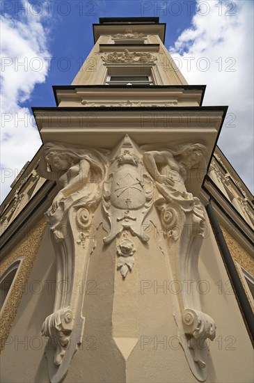 Caryatids underneath the multi-storey bay windows of an Art Nouveau building