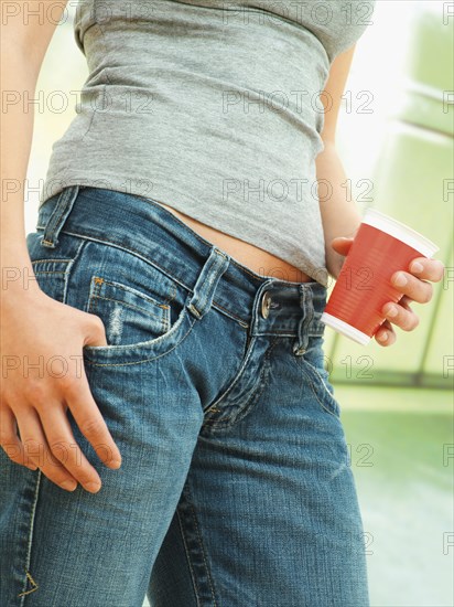 Young woman holding a red mug
