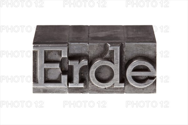 Old lead letters forming the word 'Earth'