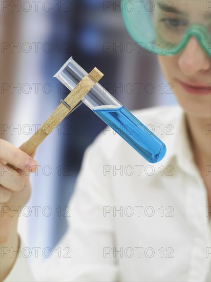 Scientist wearing a protective mask and holding a test tube