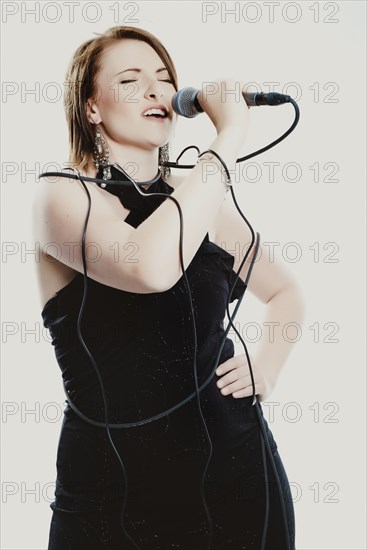 Woman singing into a microphone