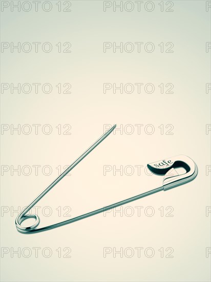 Safety pin with the word safe
