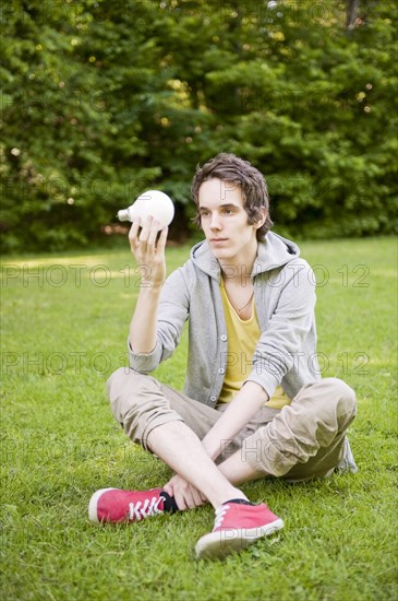 Young man sitting in nature