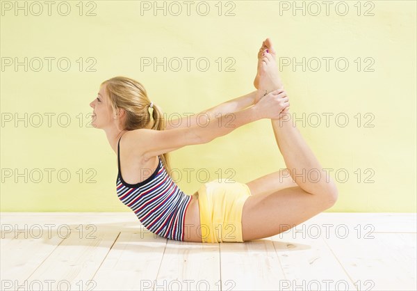 Young woman doing stretching and strengthening exercises