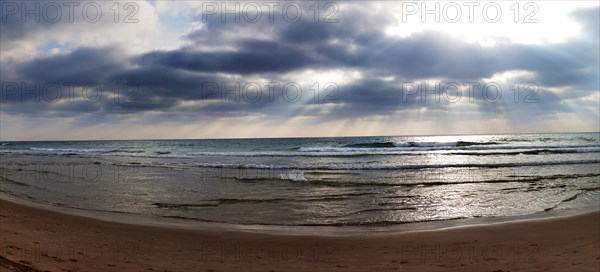 Sun rays breaking through clouds