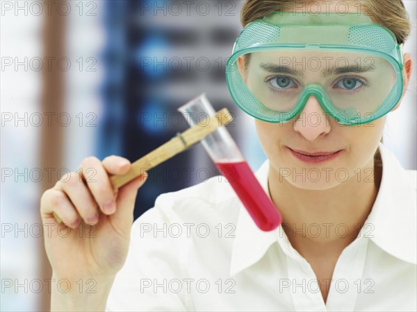 Scientist wearing a protective mask and holding a test tube