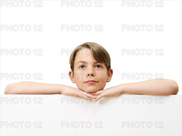 Schoolboy behind a white board