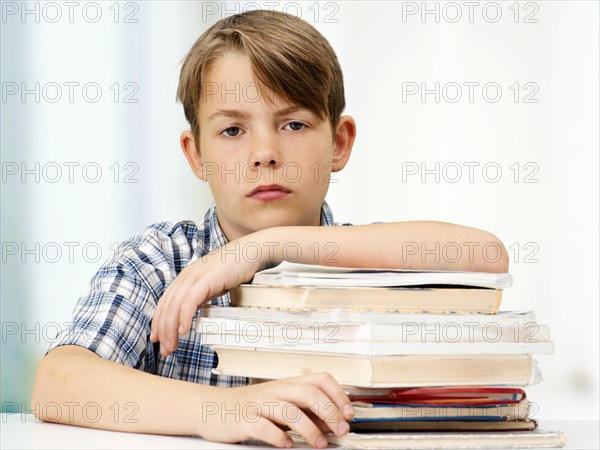 Schoolboy with a stack of books