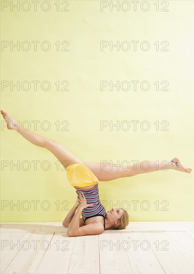 Young woman doing stretching and strengthening exercises