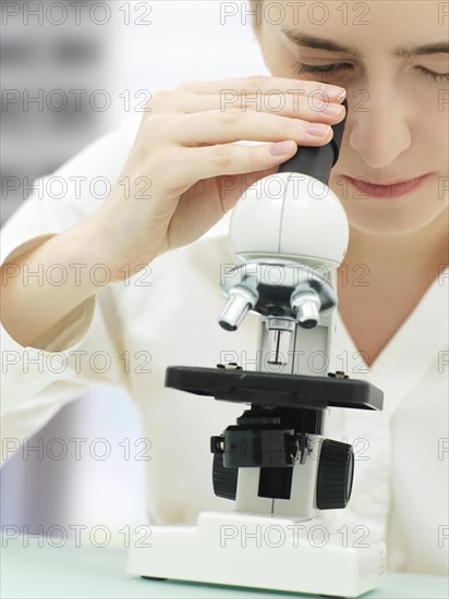 Scientist looking through a microscope