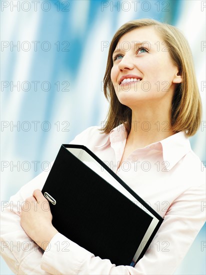 Businesswoman holding a ring binder