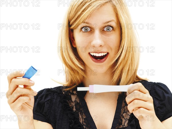 Woman holding a pregnancy test