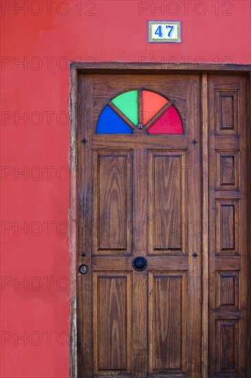 Red wall with wooden door